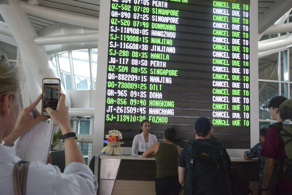 A flight information board shows cancelled flights at Ngurah Rai International Airport in Denpasar, Bali, Indonesia, Tuesday, Nov. 28, 2017. Mount Agung volcano on Bali has erupted for the first time in more than half a century, forcing closure of the Indonesian tourist island's busy airport as the mountain gushes huge columns of ash that are a threat to airplanes. (AP Photo/Ketut Nataan)